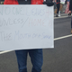 Protesters in DC hold signs quoting the poem “Home,” by Warsan Shire.